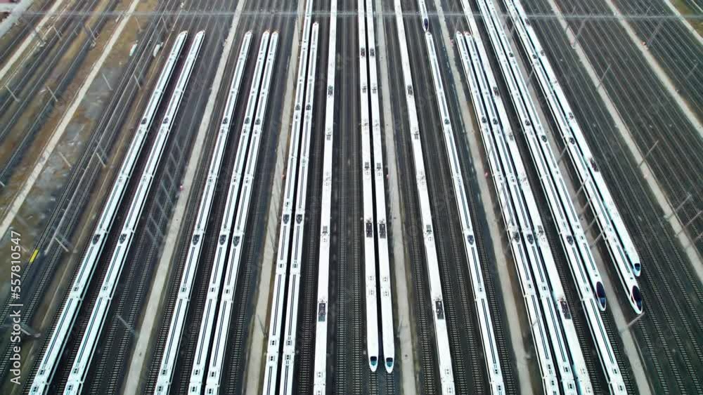 Aerial shots of multiple high-speed trains parked on railway tracks