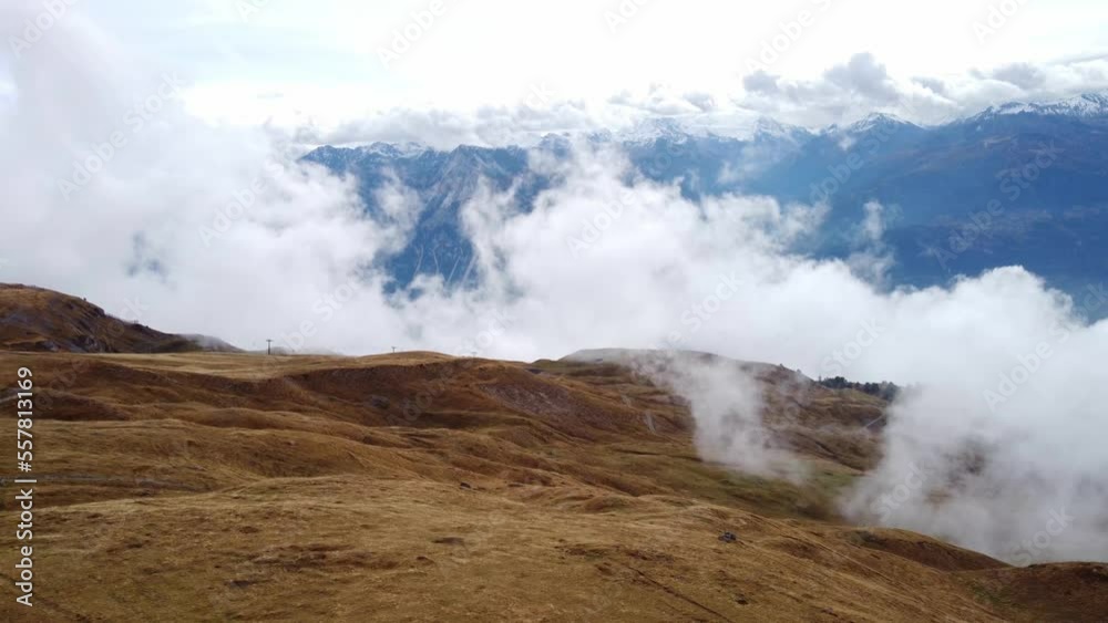 Flying drone over the mountains of Switzerland covered in fog Flying drone over the mountains of Switzerland covered in fog