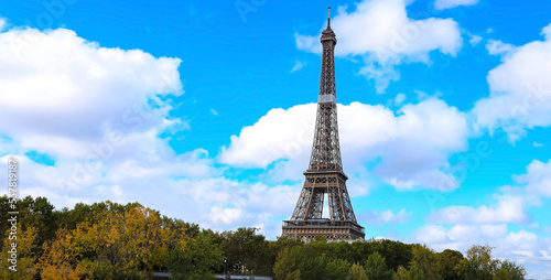 The Eiffel Tower, iconic Paris landmark as autumn trees park as Seine river with blue sky scene in Paris ,France