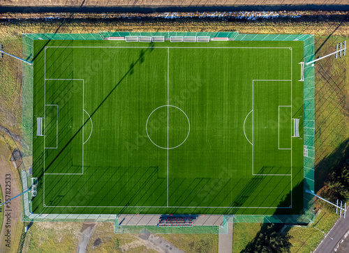 Aerial view. Sports soccer field seen from above. Greenery, grass, sun, empty, match