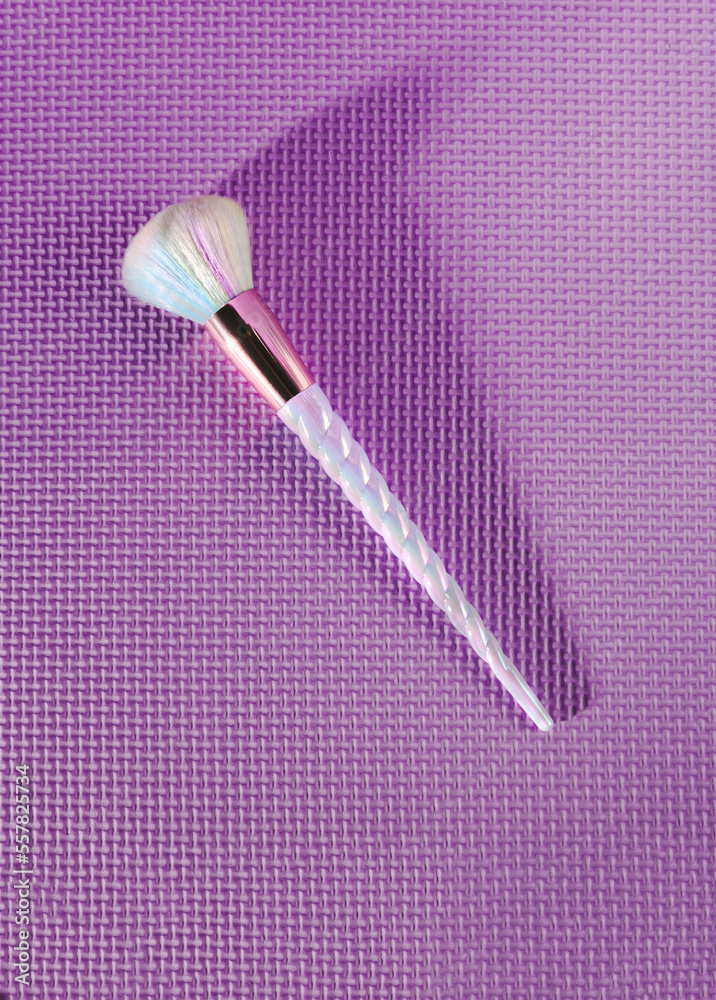 Pink vibrant unicorn makeup brush on a purple background, add your own text, logo and use for your vibrant, fun and elegant make up brand