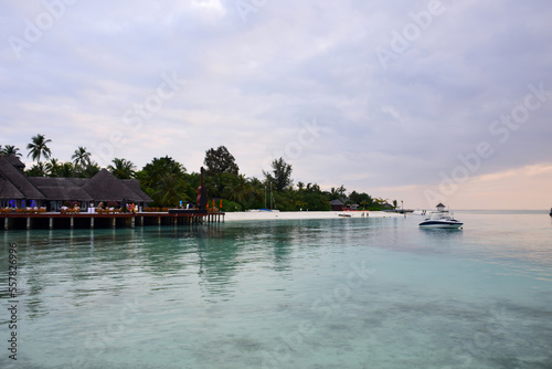 Beautiful Tropical sunset landscape in Maldives island Baa , with infinity Indian ocean sea water view and cloudy skies , perfect Honeymoon travel destination 