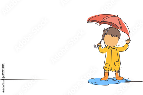 Continuous one line drawing little boy play wear raincoat and umbrella. Child playing in rain. Kid in raincoat and rubber boots plays in rain, puddle splashing. Single line draw design vector graphic