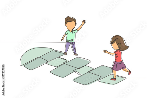 Single continuous line drawing little girl and boy playing hopscotch at kindergarten yard. Happy kids hopping at playground. Hop scotch court drawn with chalk. One line draw graphic design vector photo
