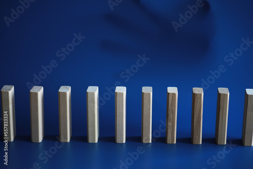 Closeup thick domino wood block in a row stop the falling  be stable in crisis  business solution concept