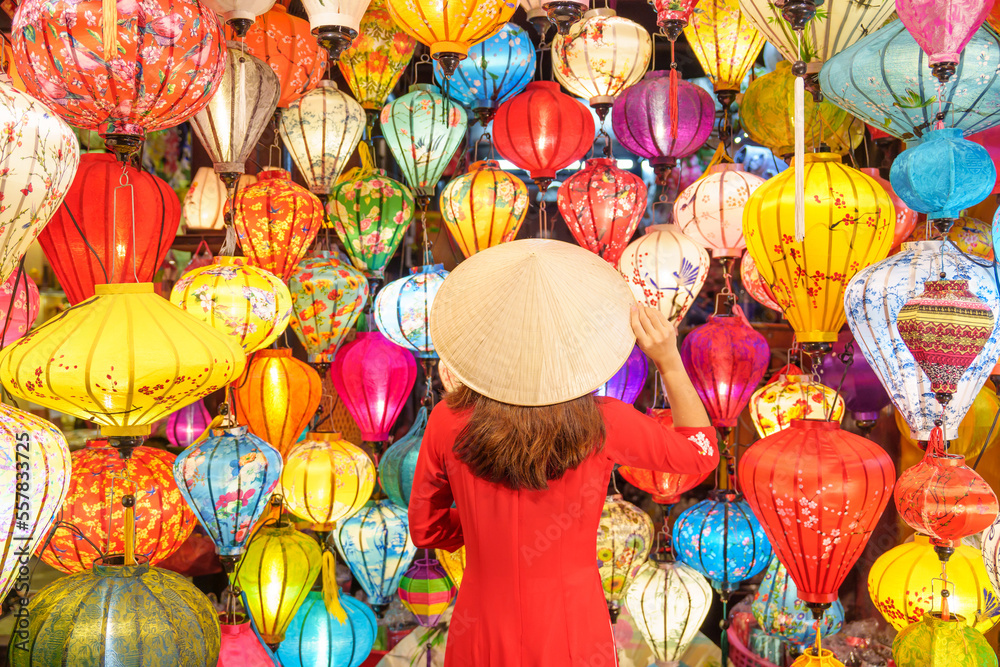 happy woman wearing Ao Dai Vietnamese dress with colorful lanterns, traveler sightseeing at Hoi An ancient town in central Vietnam.landmark for tourist attractions.Vietnam and Southeast travel concept happy woman wearing Ao Dai Vietnamese dress with colorful lanterns, traveler sightseeing at Hoi An ancient town in central Vietnam.landmark for tourist attractions.Vietnam and Southeast travel concept