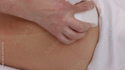 Wallpaper Mural microdermabrasion equipment, roller massage, Hardware correction. Attractive young woman is in process of improving body shape, using vacuum roller to massage client, correcting figure, anti-cellulite Torontodigital.ca