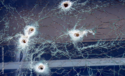 Bullet holes, Hole in glass, stones and metal balls, broken glass, cracks in glass pierced by a bullet