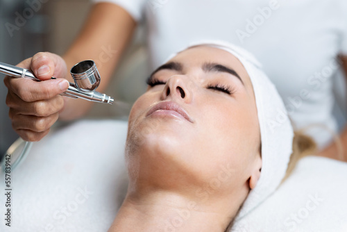 Beautiful woman getting oxygen face therapy in a beauty salon. Professional skin care treatment.