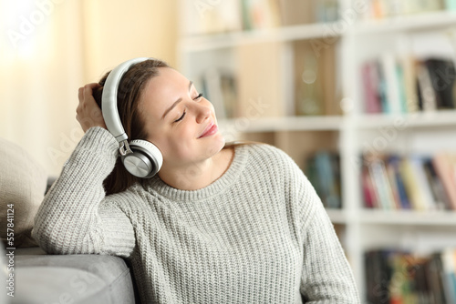 Happy teen listening to music at home Fototapeta