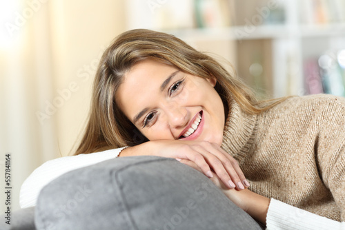 Happy woman at home looks at you