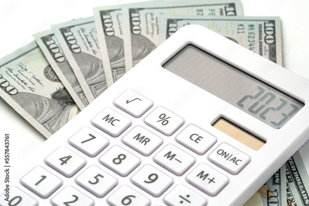 A white calculator with 2023 on the screen. A concept for recording income, expenses and controlling finances. A white calculator with 2023 on the screen. A concept for recording income, expenses and controlling finances.
