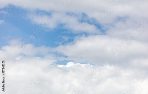 White clouds on the blue sky as a background.