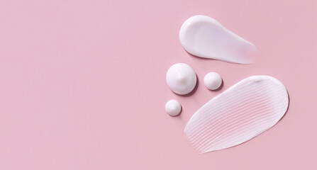 cosmetic smears cream texture on pastel pink background