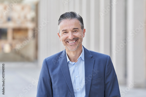 Happy mature businessman wearing blue blazer