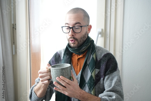 Caucasian man holding hot mug of tea 