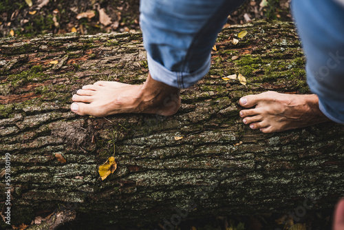 Man walking on wooden log