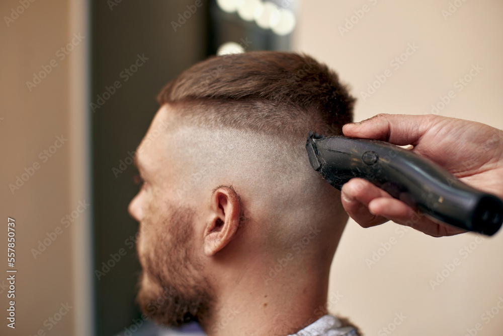 Barber shaving caucasian man in barber shop Barber shaving caucasian man in barber shop