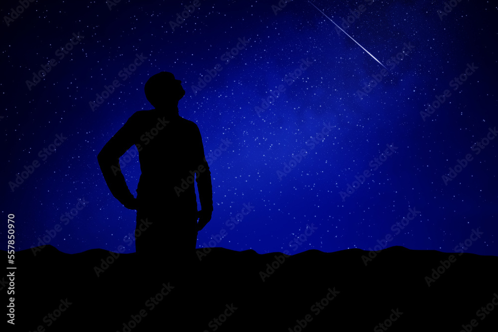 Man looking at the night sky, stars, planets and shooting stars.