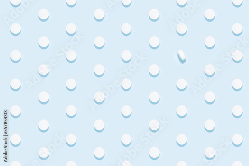 White pills as seamless pattern on soft light blue background in hard light with shadow, top view. Medical and treatment modern minimal background - remedies for prevent and teraphy disease, sickness.