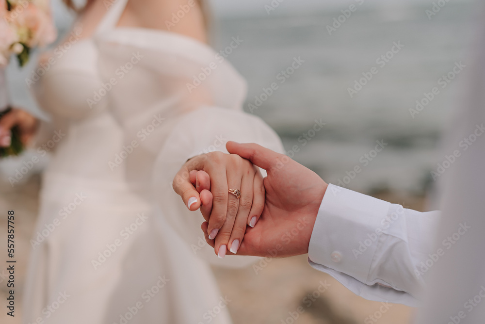 Couple's hand in front of the black sea