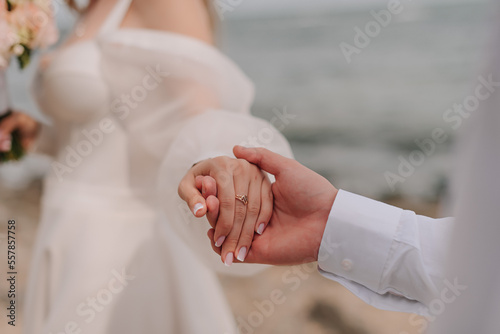 Couple's hand in front of the black sea