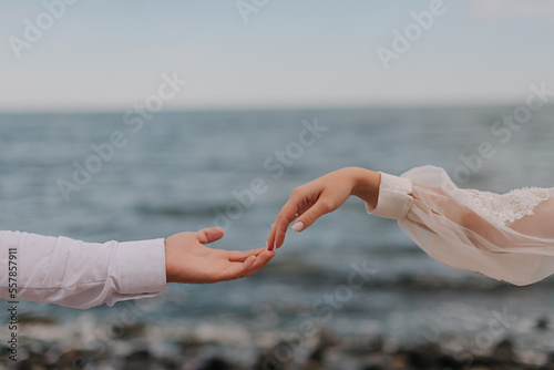 Couple's hand in front of the black sea