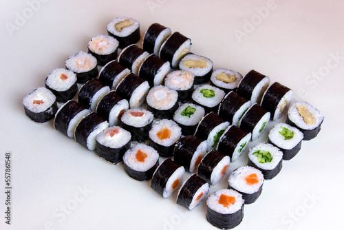 Side view sushi set on white background. Syake maki rolls