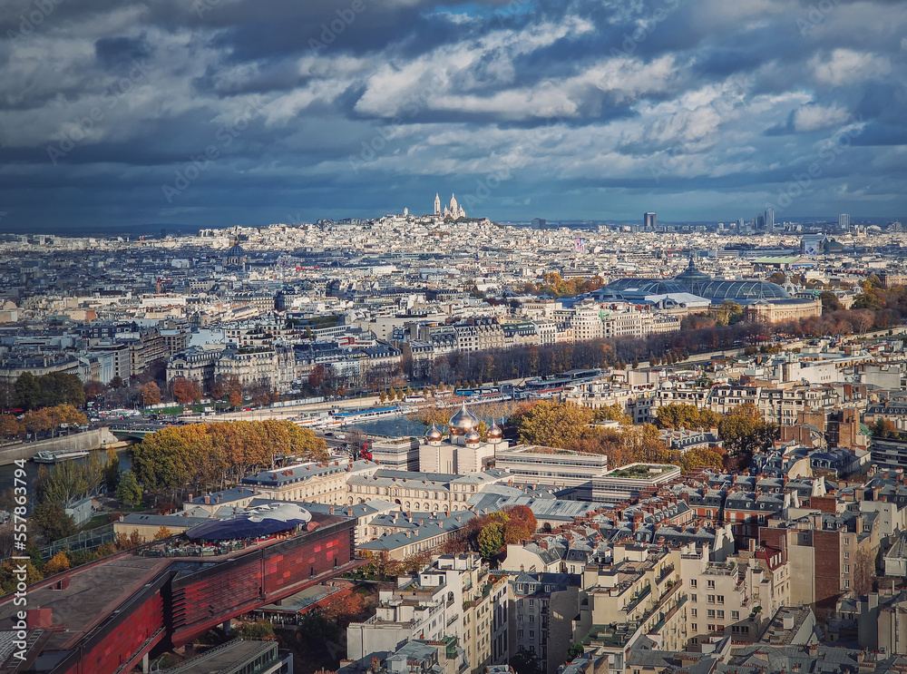 Panoramic view over the Paris city to the Sacre Coeur de Montmartre basilica on the hill, France. Autumn parisian cityscape