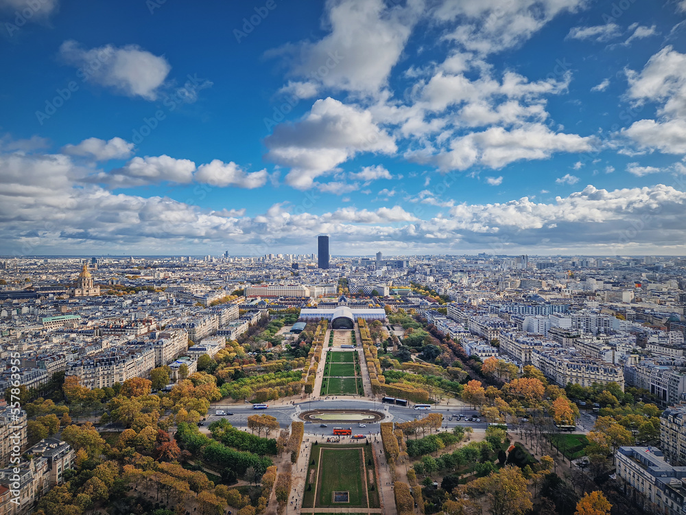 Paris cityscape view from the Eiffel tower heights, France. Montparnasse tower and Les Invalides seen on the horizon panorama. Beautiful autumn colors