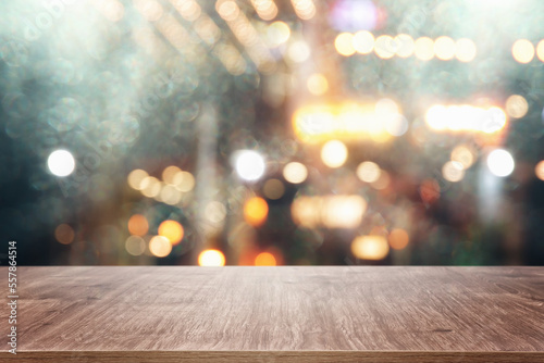 background Image of wooden table in front of abstract blurred restaurant lights