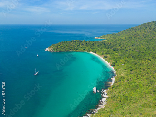 Aerial view of boats with clear blue turquoise seawater, Andaman sea in Phuket island in summer season, Thailand. Water in ocean material pattern texture wallpaper background.