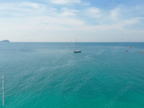 Aerial view of boats with clear blue turquoise seawater  Andaman sea in Phuket island in summer season  Thailand. Water in ocean material pattern texture wallpaper background.
