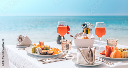 Fototapeta Naklejka Na Ścianę i Meble -  Luxury sunny breakfast table beautiful tropical sea blur. Idyllic romantic morning love couples at summer holiday. Honeymoon romance togetherness vacation concept. Travel lifestyle, destination dining