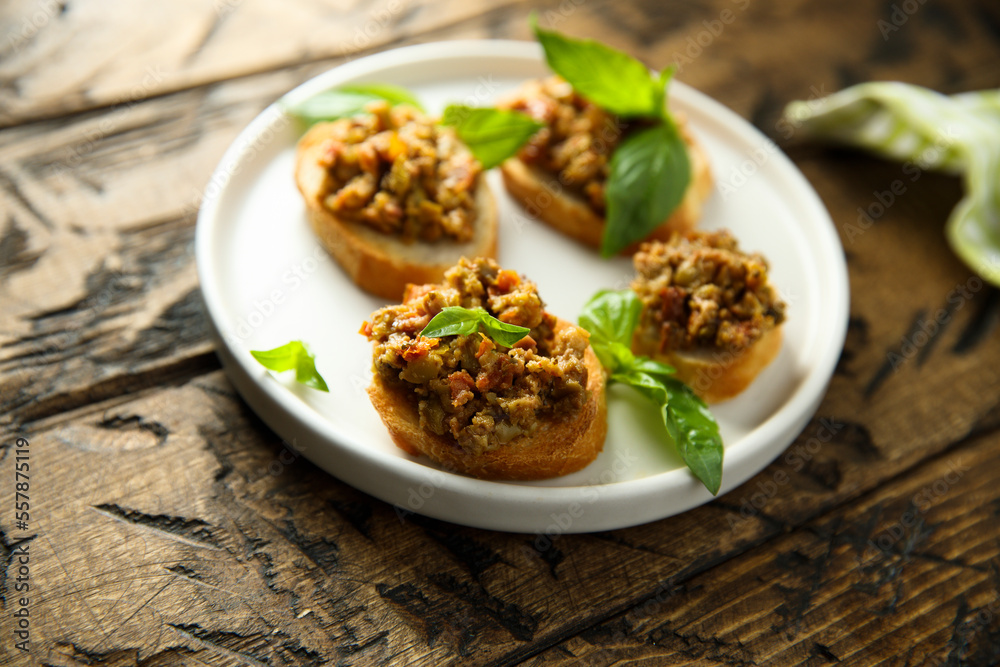 Crostini with olive tapenade and basil