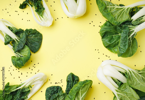 Bild auf Leinwand Frame made of fresh pak choi cabbage on yellow background