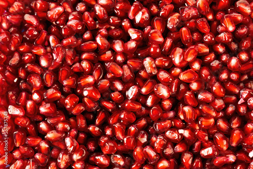Pomegranate seeds close up. Red food background