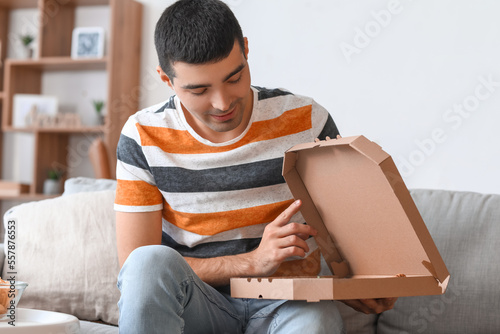 Young man with box of tasty...
