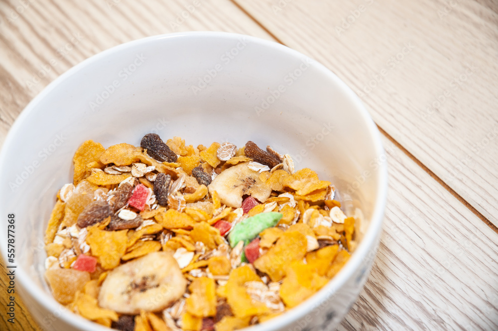 Healthy breakfast - cornflakes in a bowl on a table. Healthy breakfast - cornflakes in a bowl on a table.