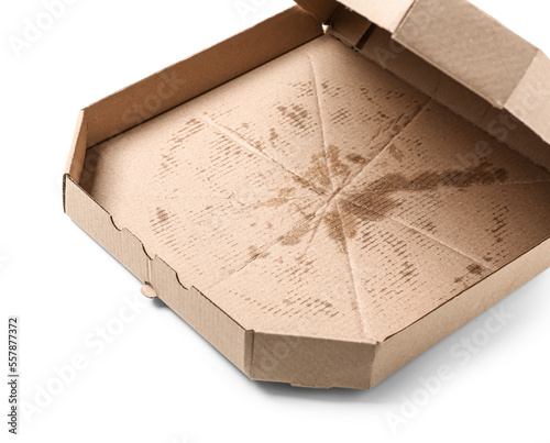 Empty greasy pizza box isolated on white background, closeup