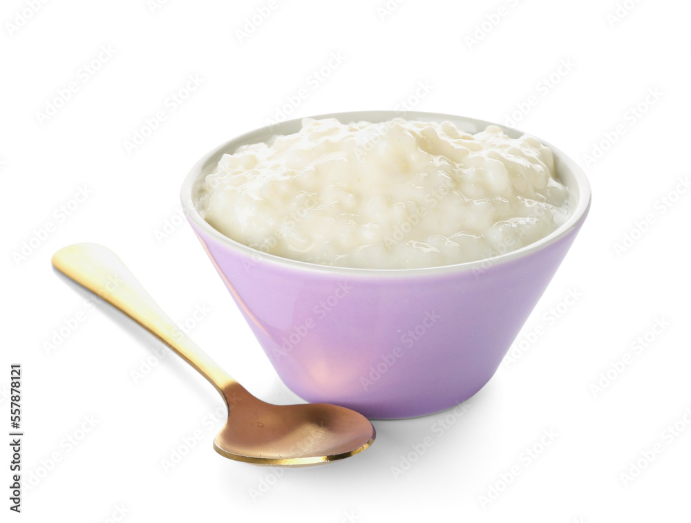 Bowl with delicious rice pudding and spoon on white background Bowl with delicious rice pudding and spoon on white background