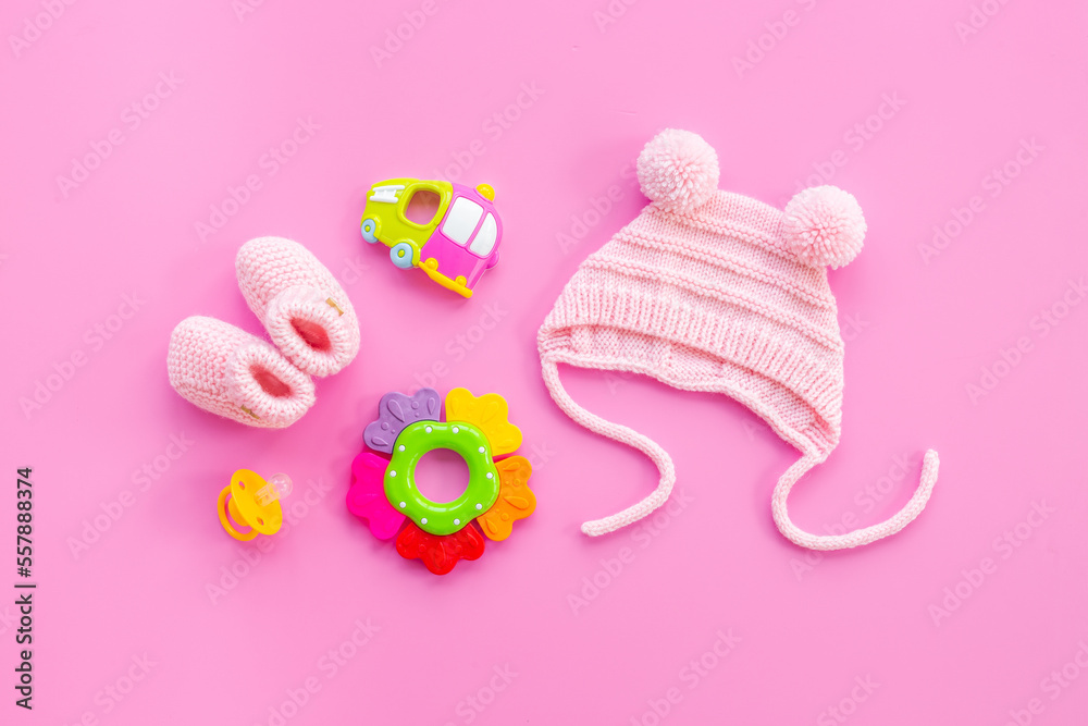 Baby girl pink hat with booties and accessories, top view Baby girl pink hat with booties and accessories, top view