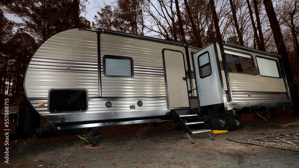 Camper trailer in a dark forest