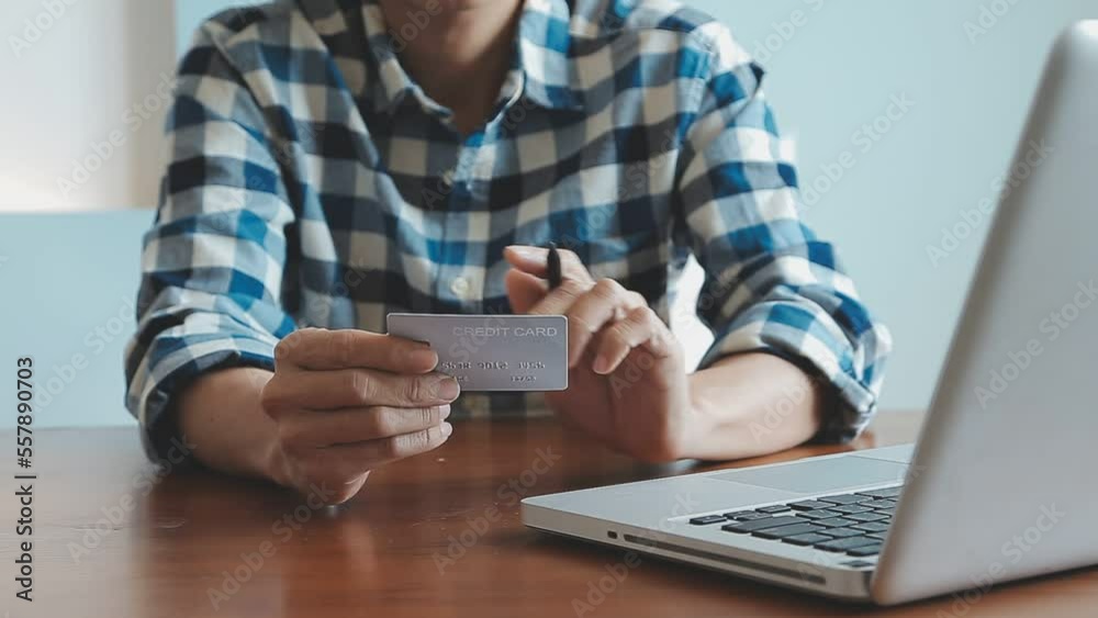 Hands holding credit card and using laptop. Online shopping Hands holding credit card and using laptop. Online shopping