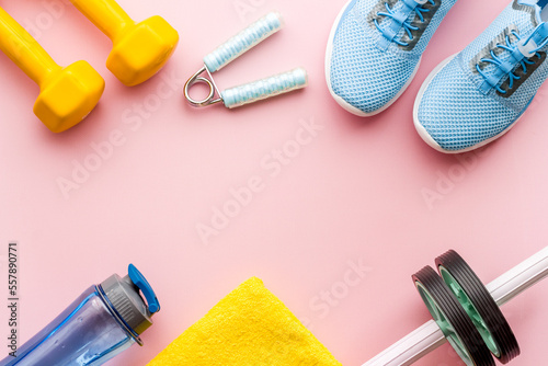 Sport fitness flatlay with sneakers and dumbbells, top view