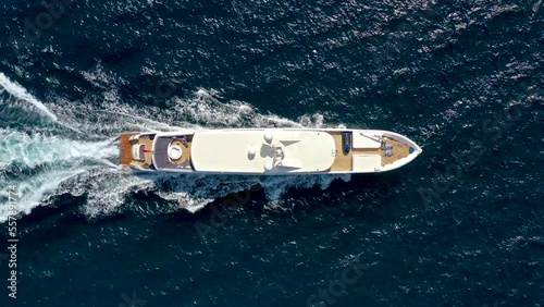 bird's eye drone view of luxury yacht cruising at sea