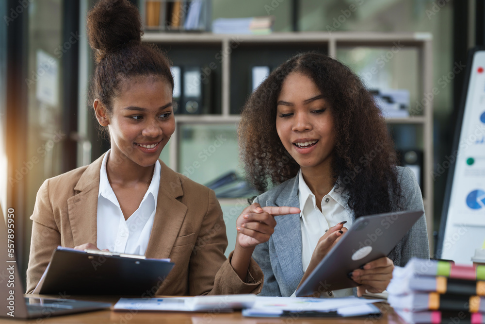 An African American businesswoman participates in a staff meeting and working together at workplace. An African American businesswoman participates in a staff meeting and working together at workplace.