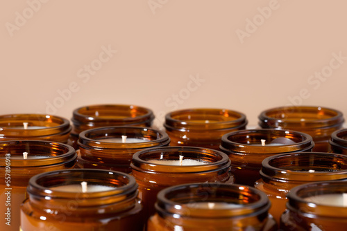 Group of Handmade Soy and coconut wax candles in a Amber and opaque container, brown glass jar. Natural eco friendly organic candles. Trendy concept diy. Vegan plastic free product. Copy space.