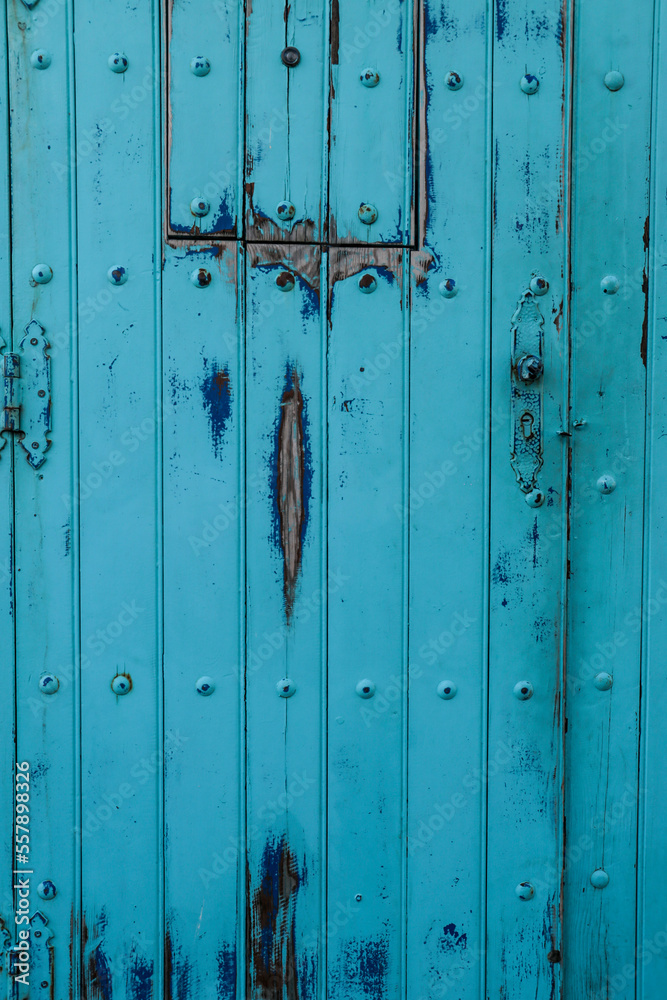 Fototapeta premium Background of Old Blue wooden door in Spain