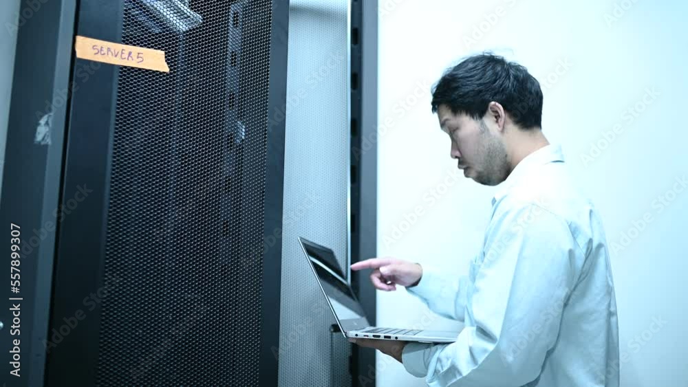 Computer engineer is setting up network in server room,Systems Maintenance Technician Computer engineer is setting up network in server room,Systems Maintenance Technician